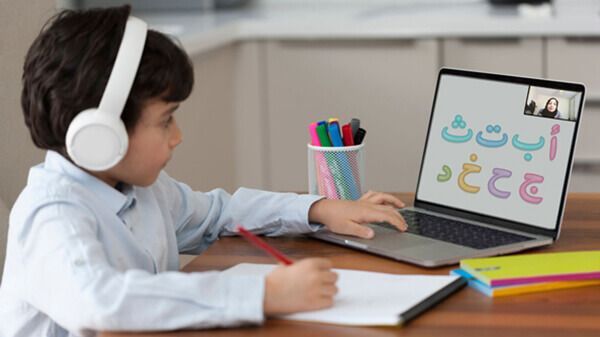 Child wearing headphones and reading Quran in online Quran classes for kids